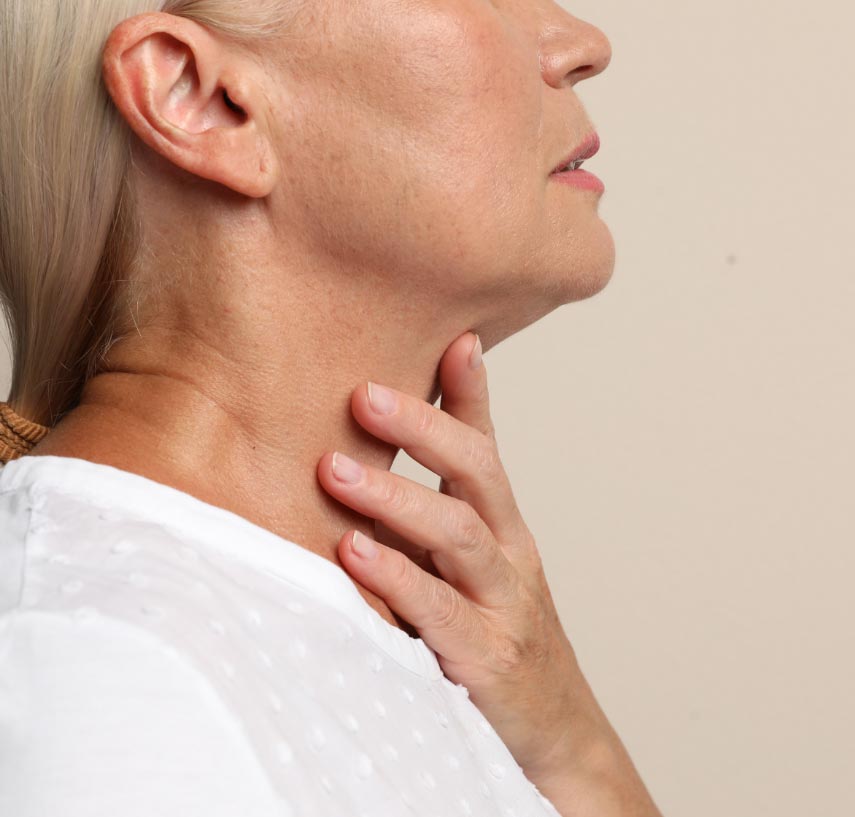 Woman feeling her neck